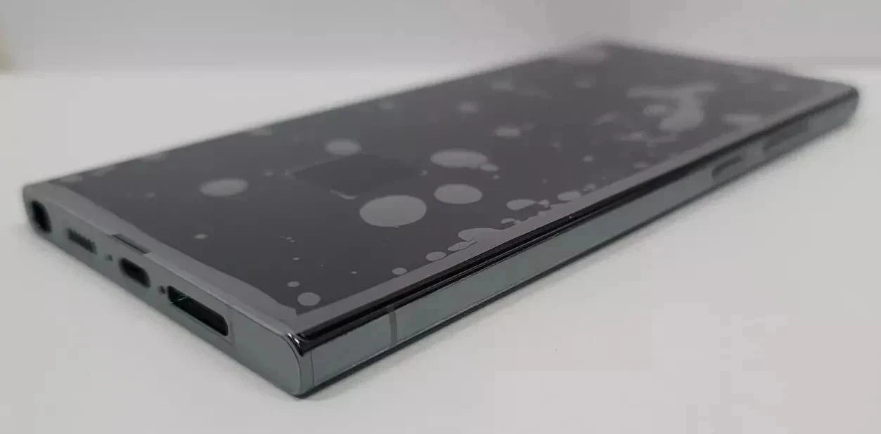 A black s23 ultra shown from an angled top-down view on a light gray background.